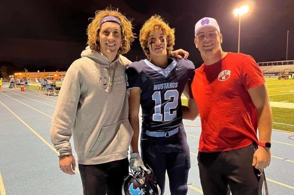 Older brothers Alex and Noah show up to support Mick in his football journey.
