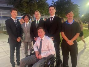 Despite being seriously injured Traugott poses next to his friends before a homecoming dance. 