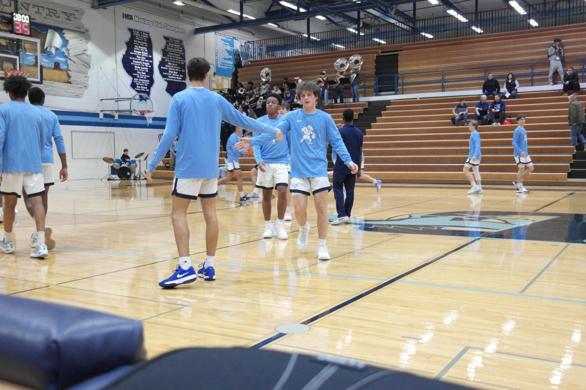 The boys varsity basketball team warms up to play Nazareth academy. 