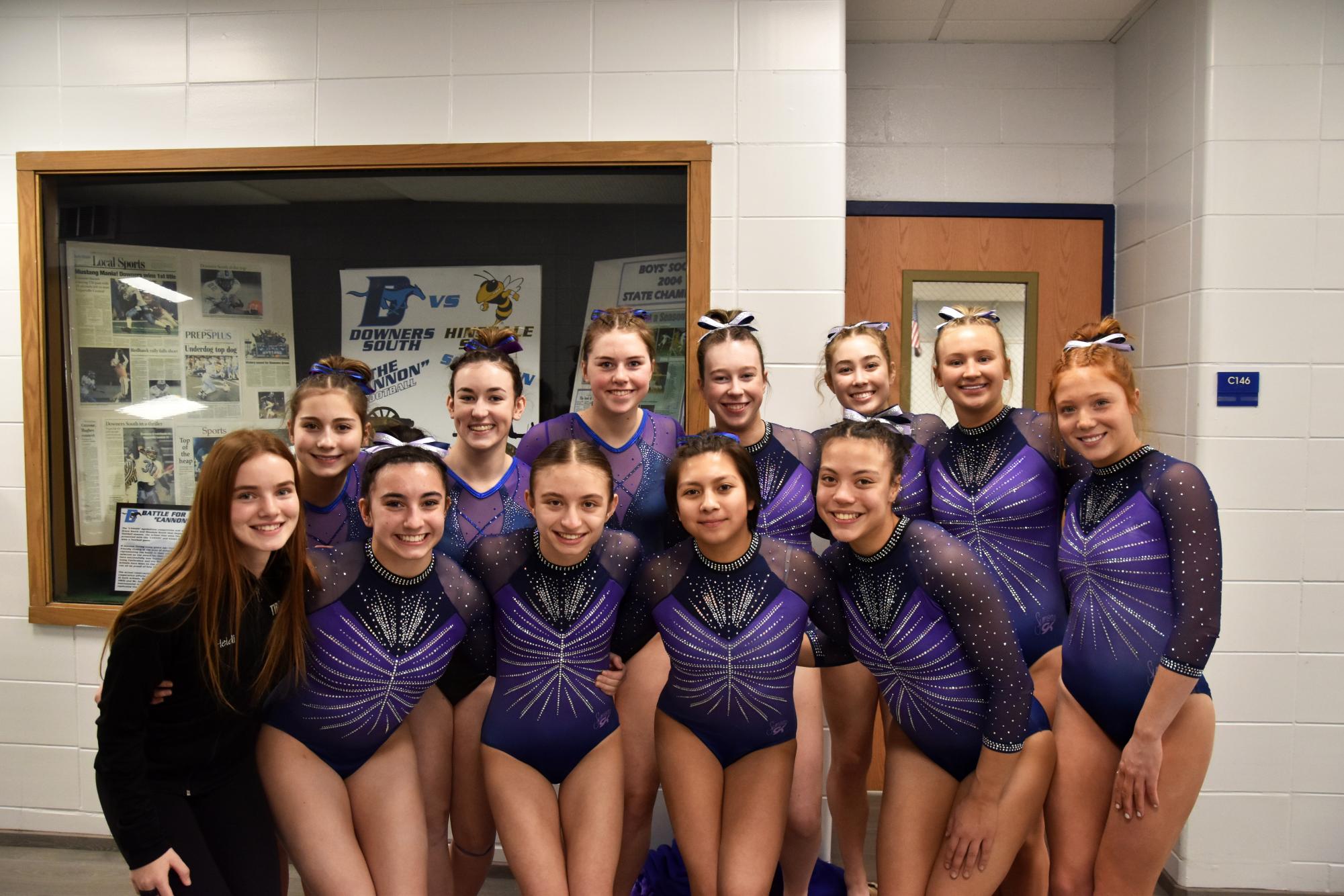 The Trostangs huddle together after  breaking their team score record at the West Suburban Gold Conference meet.