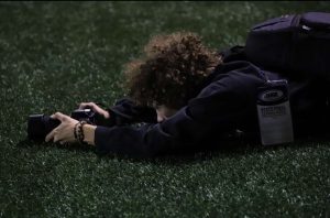 Senior Shawn McNamara taking photos for the DGS football team. 