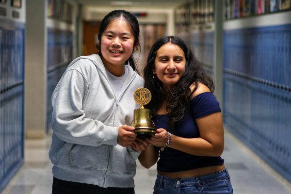 Juniors Lyia Zhang and Sarah Gerges Rodriguez pose with the Key Club Bell.