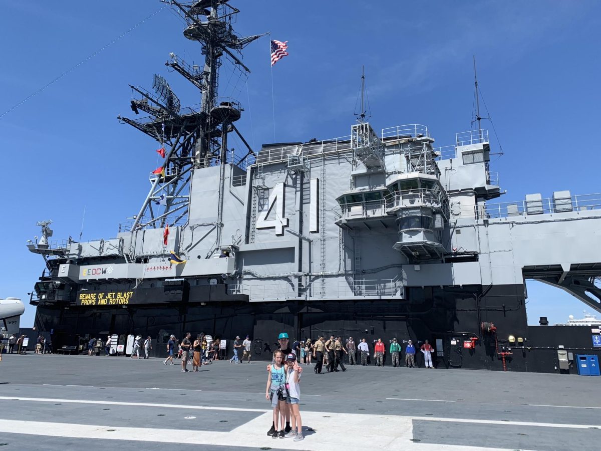 Grace Lube poses in front of the U.S.S. Midway with her siblings, at a young age, ensuring she learned the true history of our country.