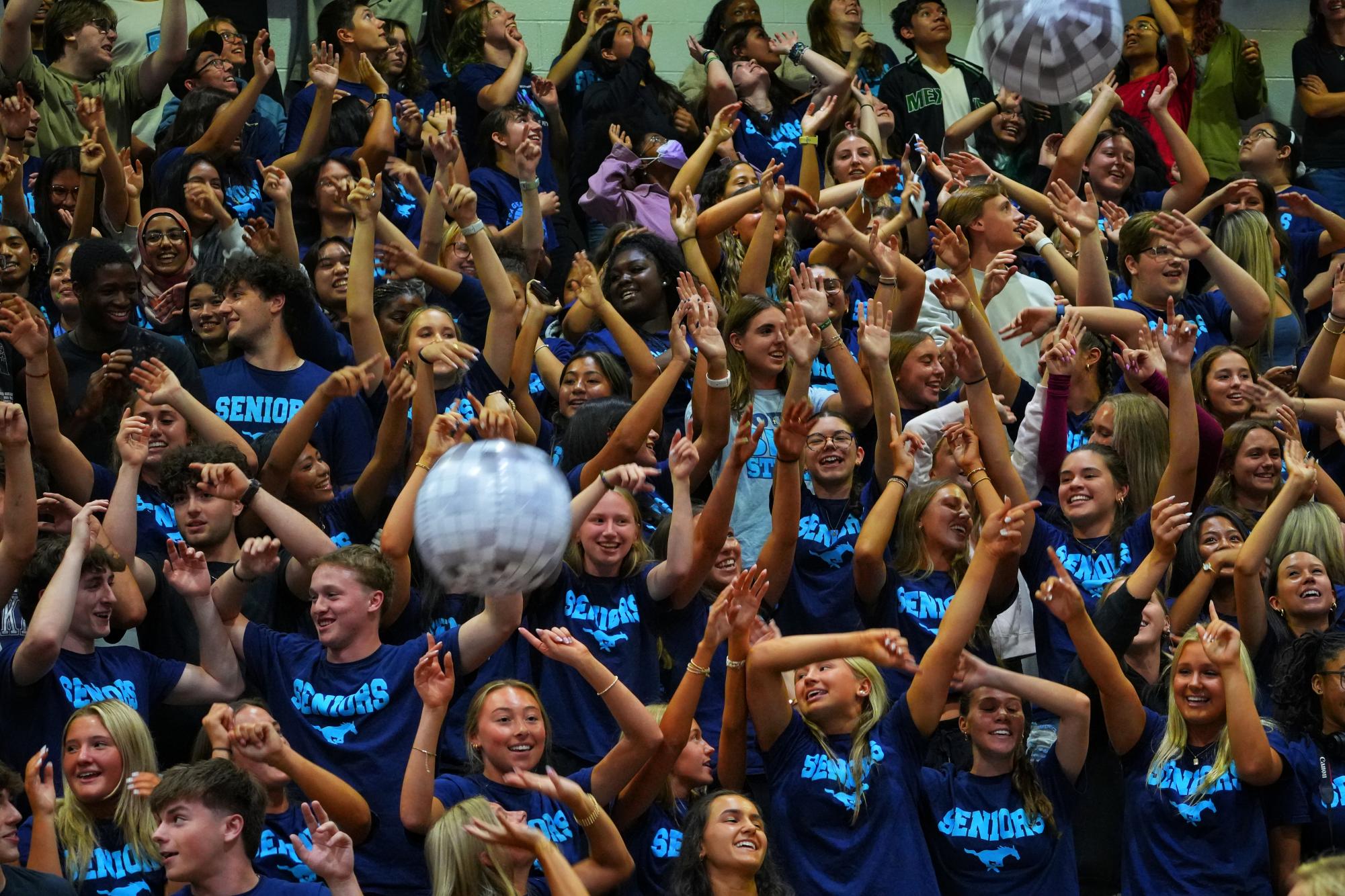 The Senior section sings during the homecoming assembly.