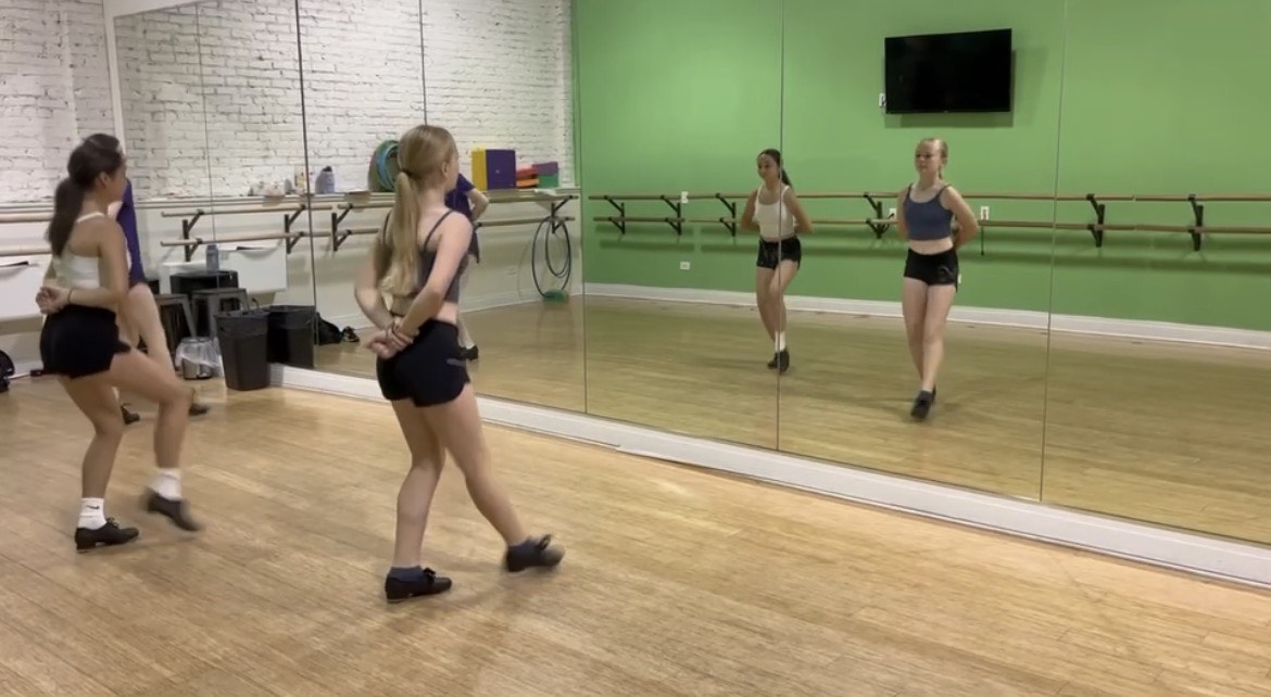 Crowley practices her competition tap routine in her studio alongside fellow dancers.
