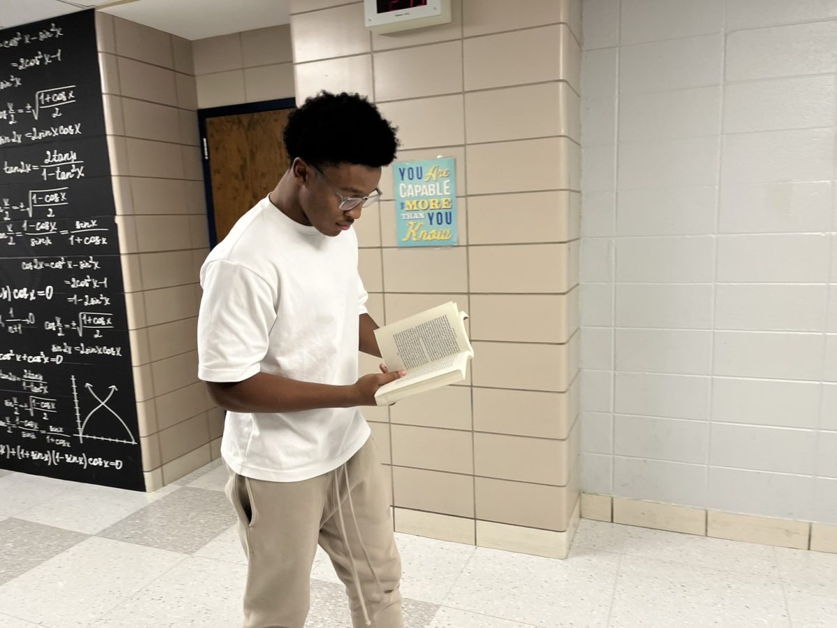 Male students brandish novels in the hallway, showing off their academic prowess