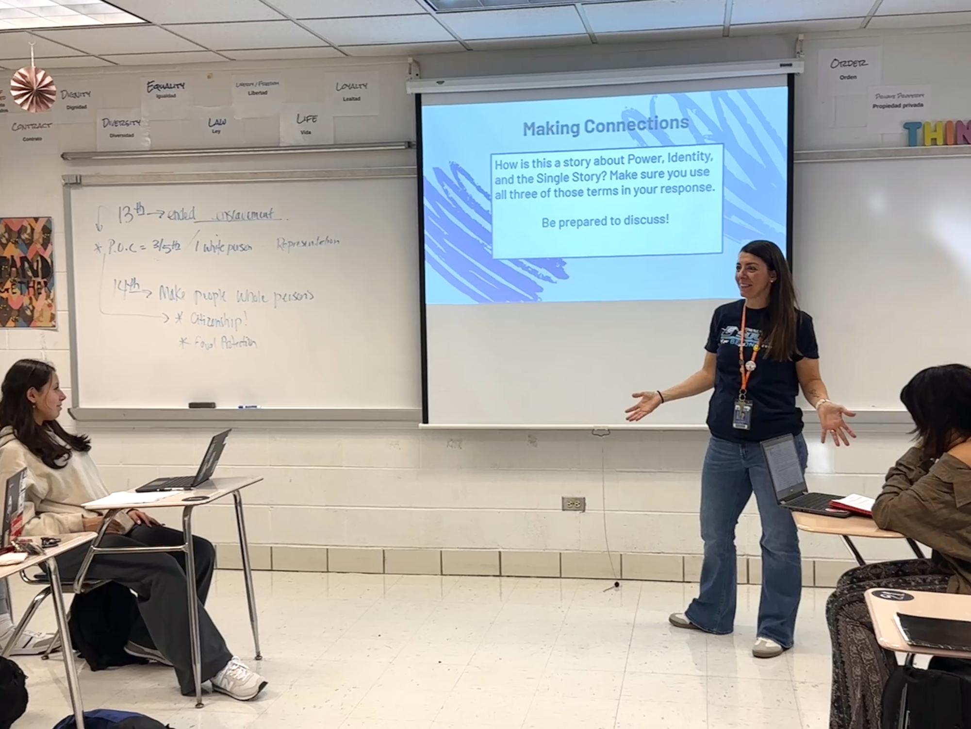 Teacher Kristyn Campos giving class the agenda for the day and beginning an open discussion
