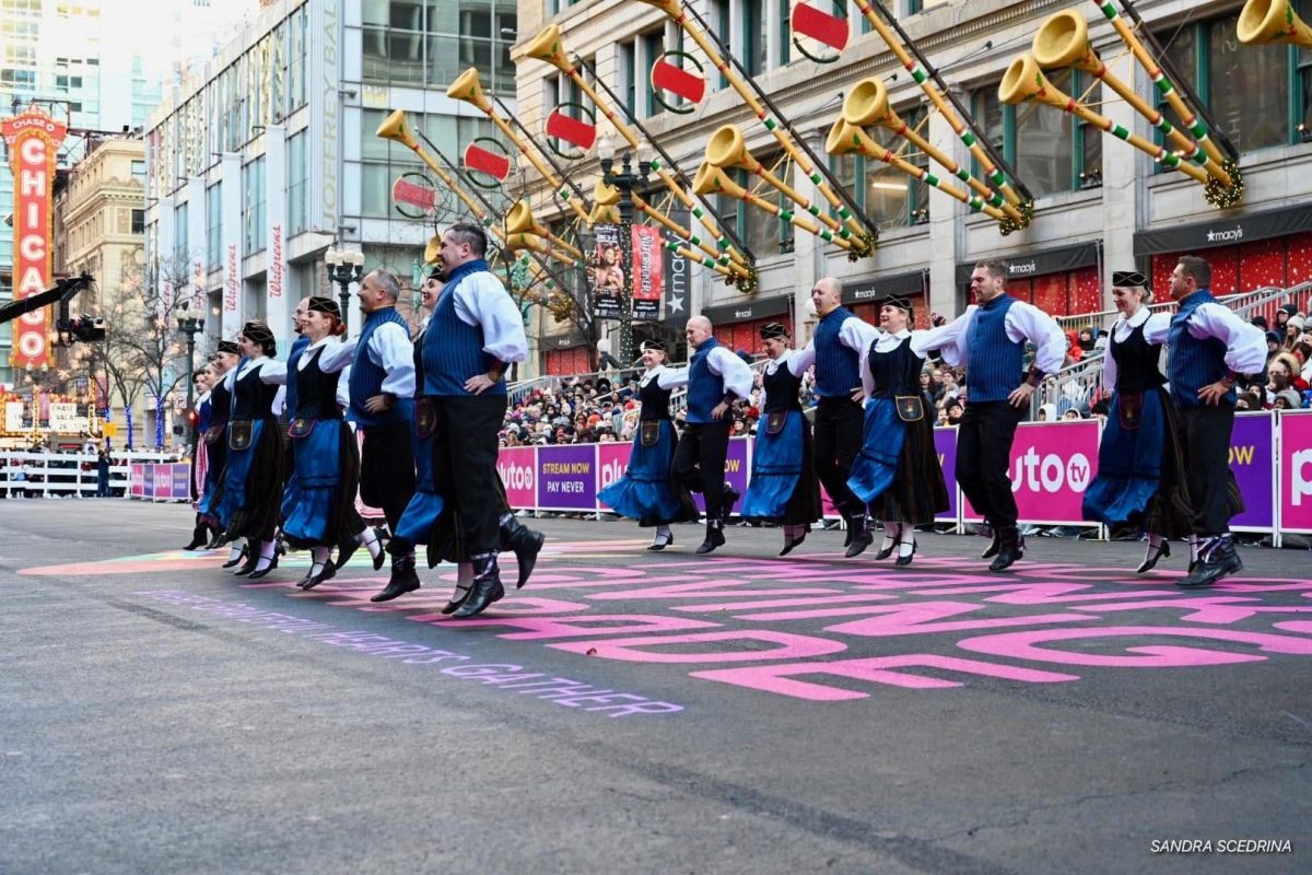 Adult Suktinis dancers representing their culture at the Thanksgiving day parade in Chicago. Credited to the XVII Lithuanian Folk Dance Festival of North America.