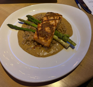The honey mustard scottish salmon presented with lemon dijon sauce, couscous and asparagus.
