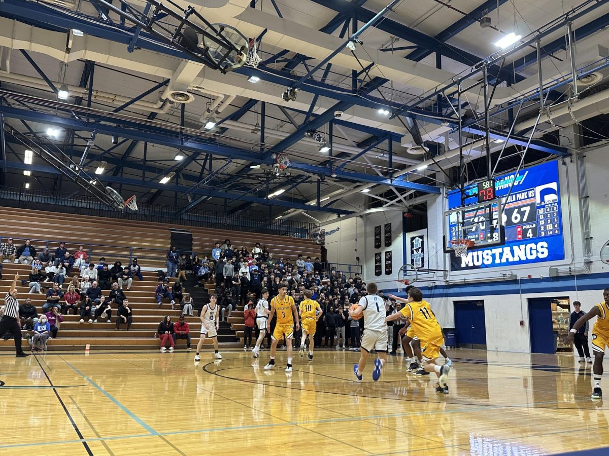 Junior Brennan Mcnarma looks for an opening with 7.8 seconds left on the shot clock against the Lincoln Park Lions.