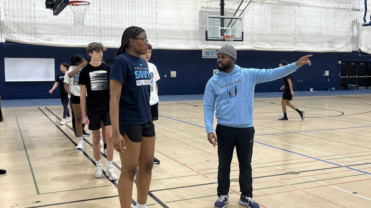 Coach Finley directs an athlete during an evening practice. 