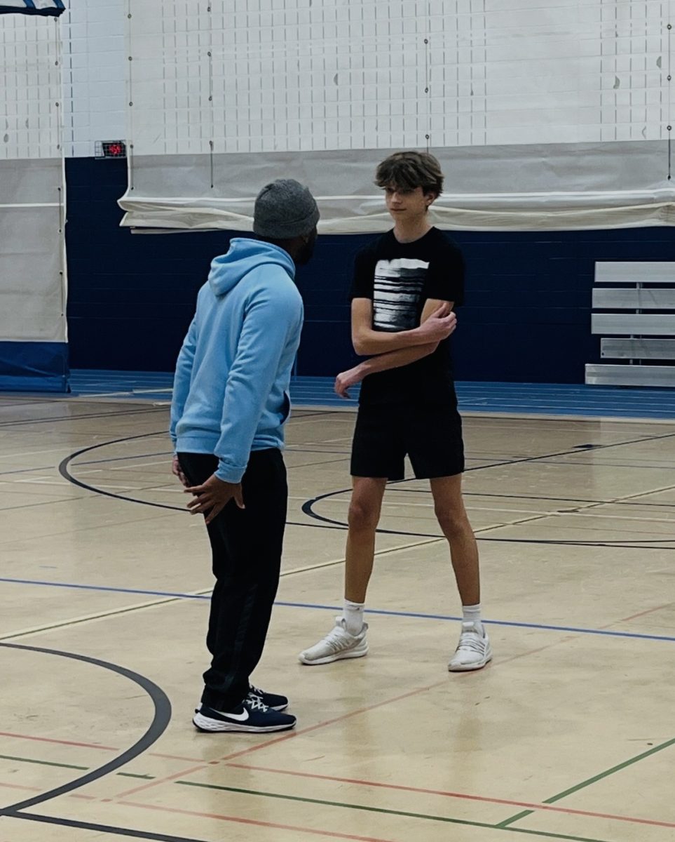 Finley converses with an athlete during practice. 