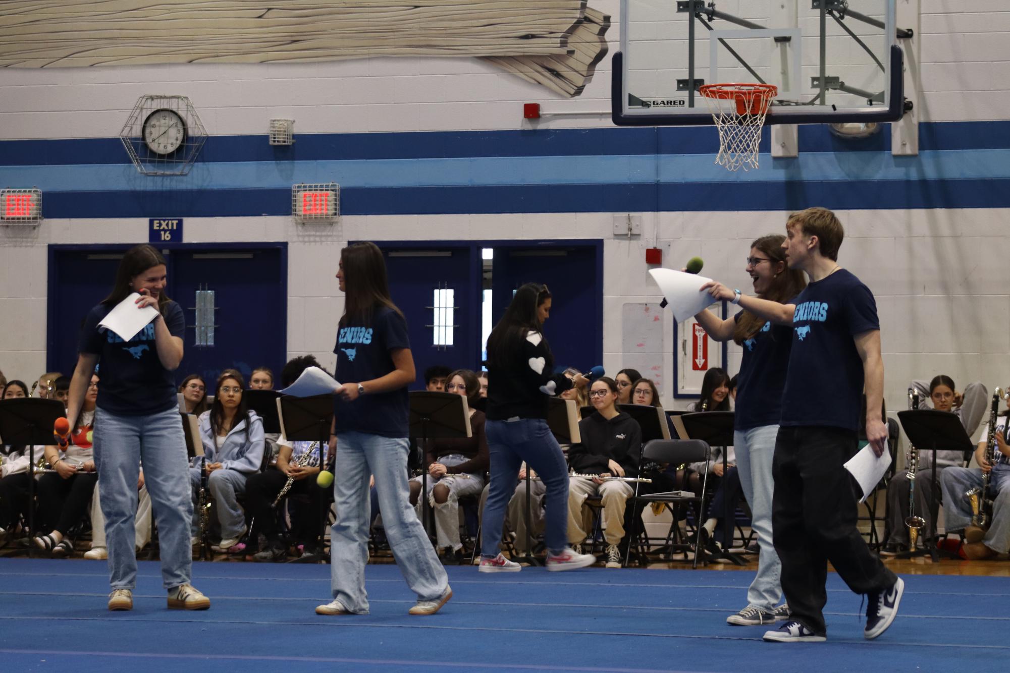 Seniors lead the spirit assembly as MCs, guiding the event with energy, confidence, and school pride.
