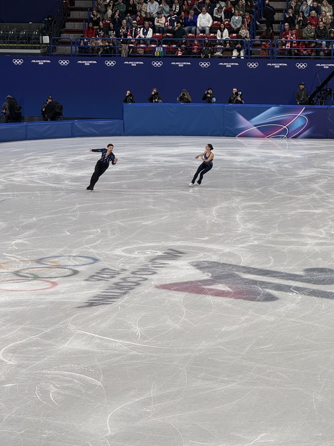 Figure skating pair dances in unison.