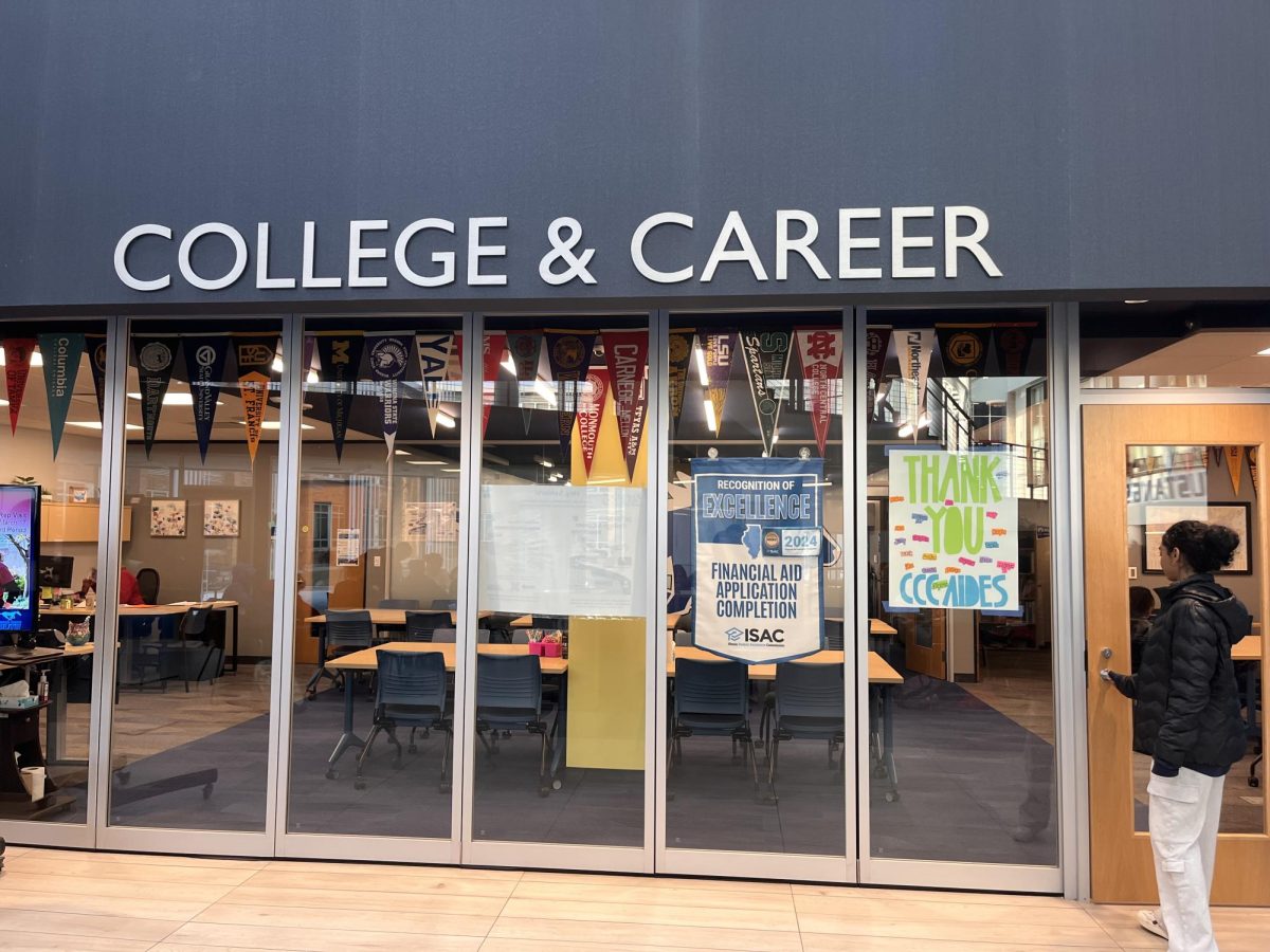 A student walks into the College & Career Center, which has a multitude of resources for college application help and financial planning for college.