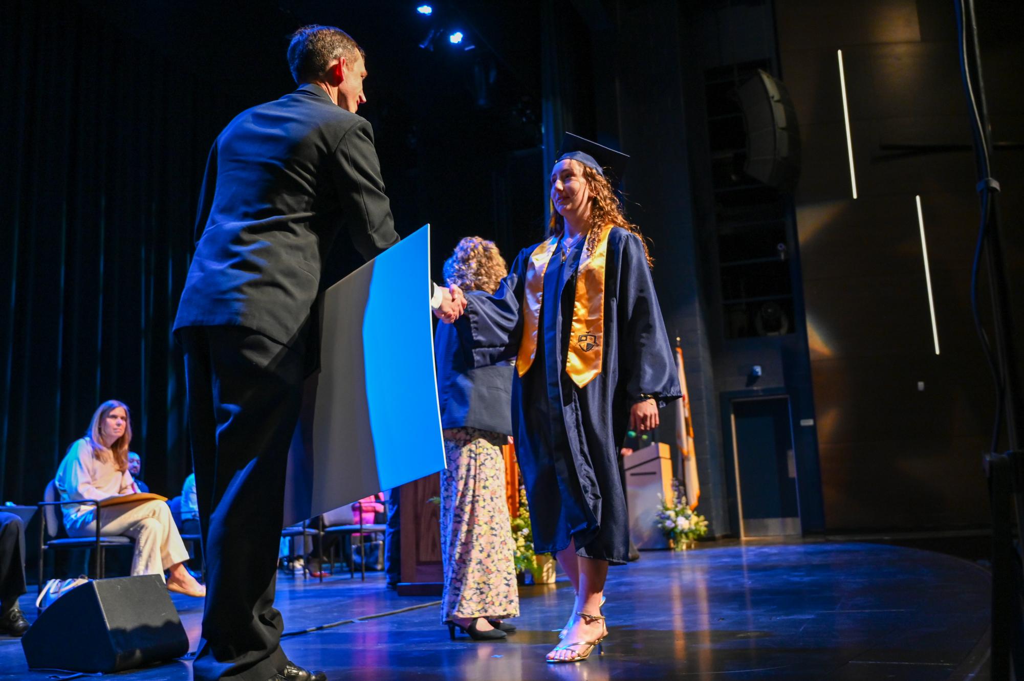 Senior Eleanor Shifley walks the stage to receive a full ride scholarship from the NROTC for her pre-med college education.