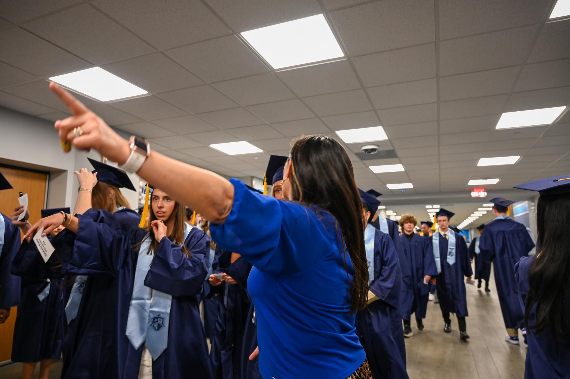 As high honors and distinguished honors students are lined up by alphabetical order to be introduced to the audience
