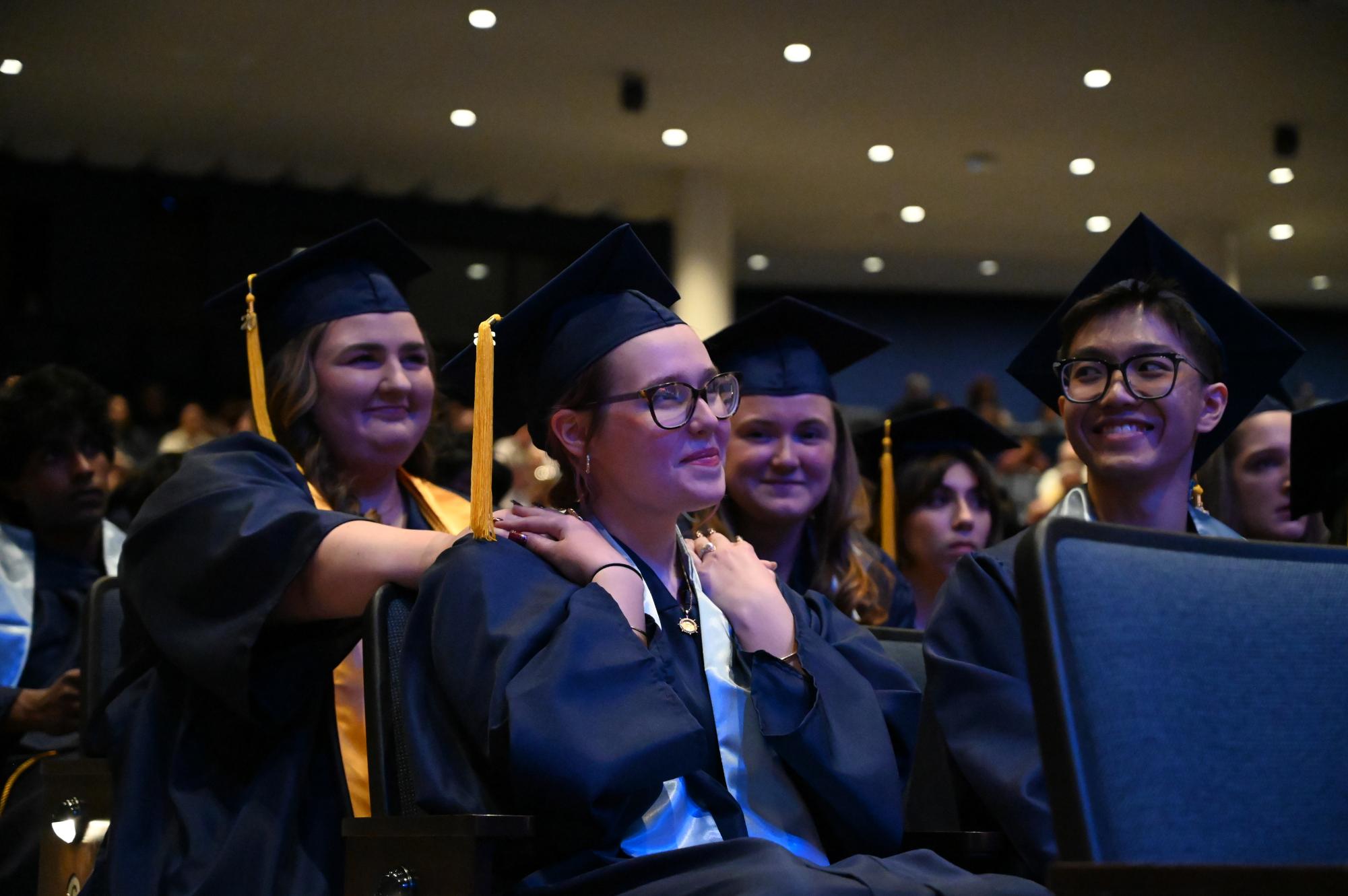 Students hold their friends hands as the outstanding senior in music is announced.