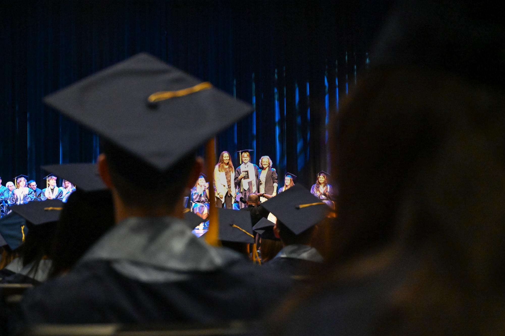 Seniors look onto the Performing Arts Center main stage as senior awards are presented for the class of 2026.