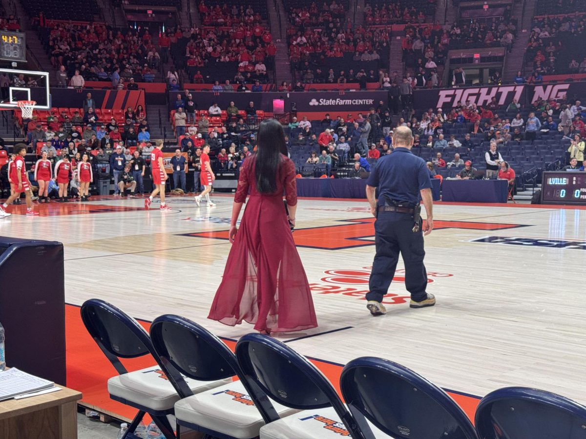 Led by an official, Mariano steps onto the court, filled with a mix of excitement and suspense.