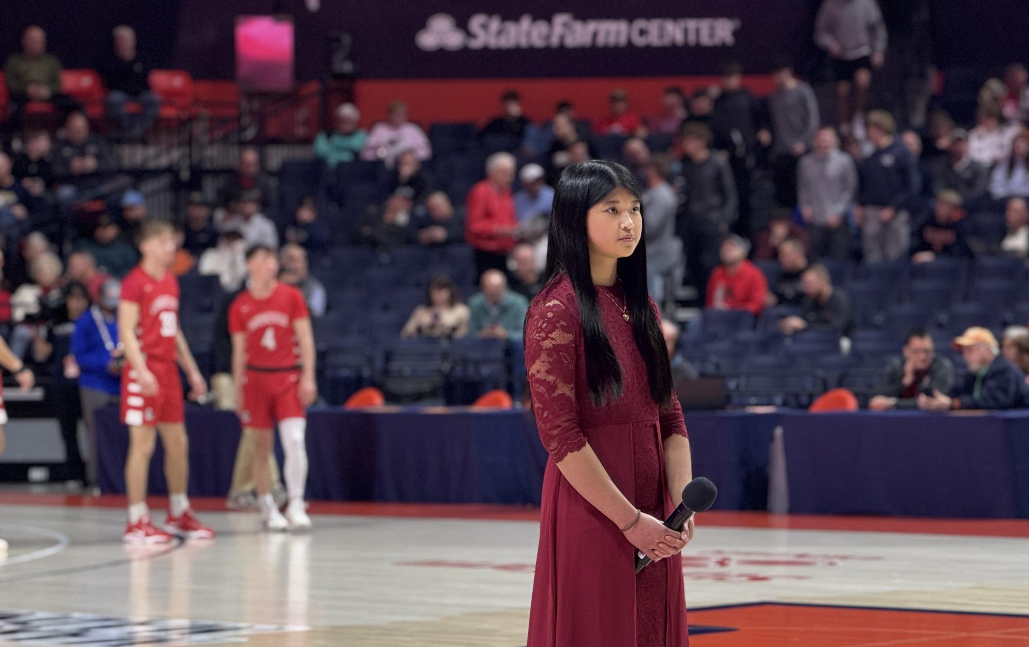 Junior Cristina Mariano stands poised, anxiously waiting moments before singing the national anthem.