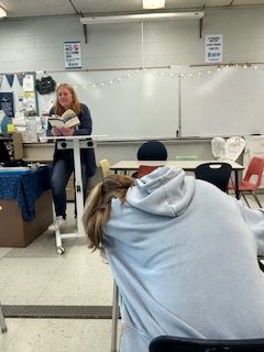 Mrs. Skinner attempts to teach while a student slumbers.