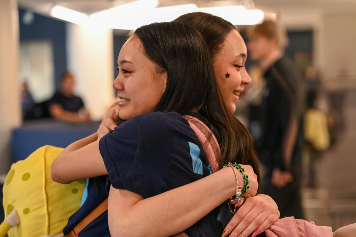 Seniors Jamie Snoody and Shania Azarcon embrace after the final bell on the seniors last day of high school.