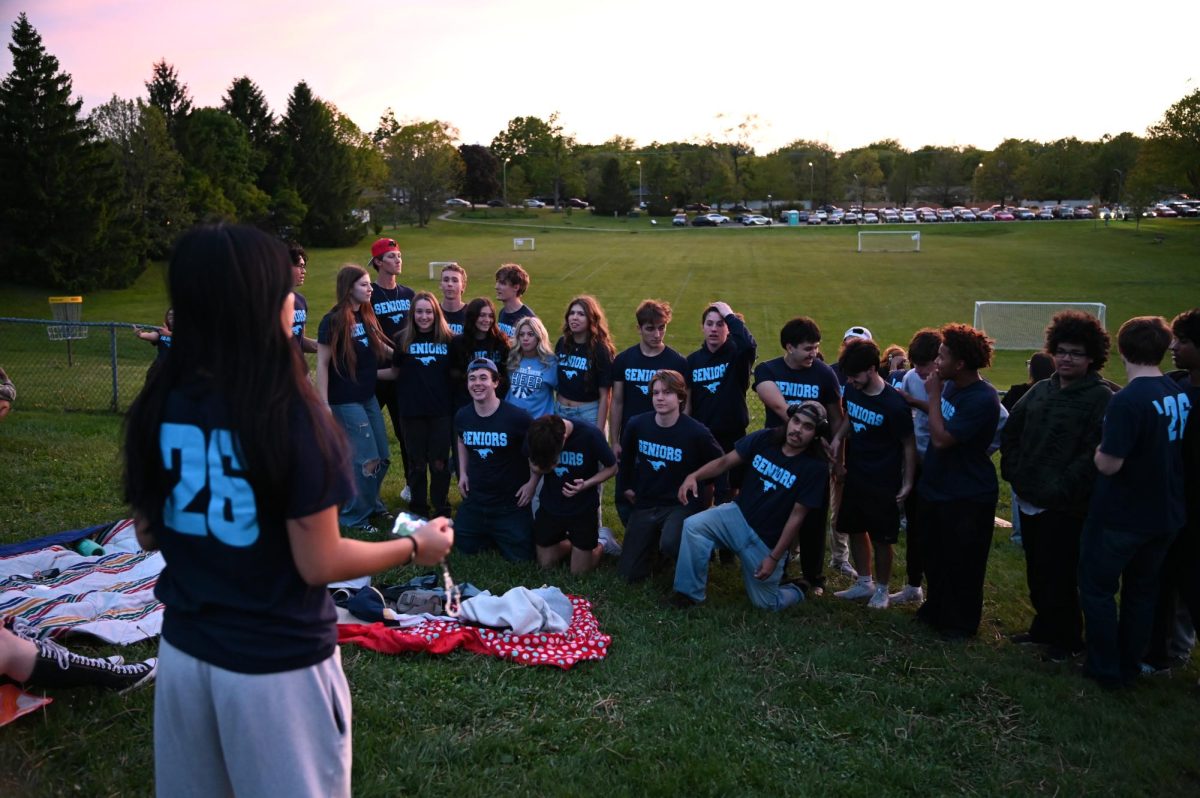 Posing Infront of the sunset, seniors pose for their final student run event of their high school careers. 